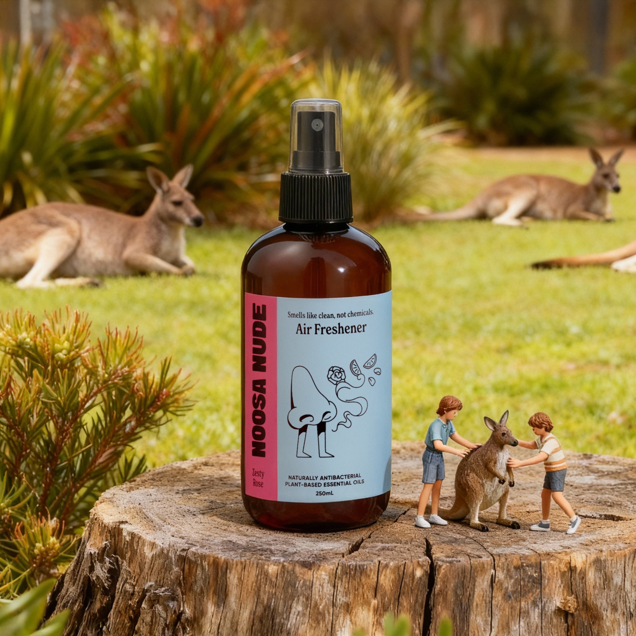 Bottle of Noosa Nudge air freshener on a wooden stump with kangaroos in the background